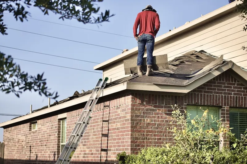 Professional roofer working on a residential roof in Century Park